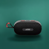 Black portable speaker with red accents on a teal background