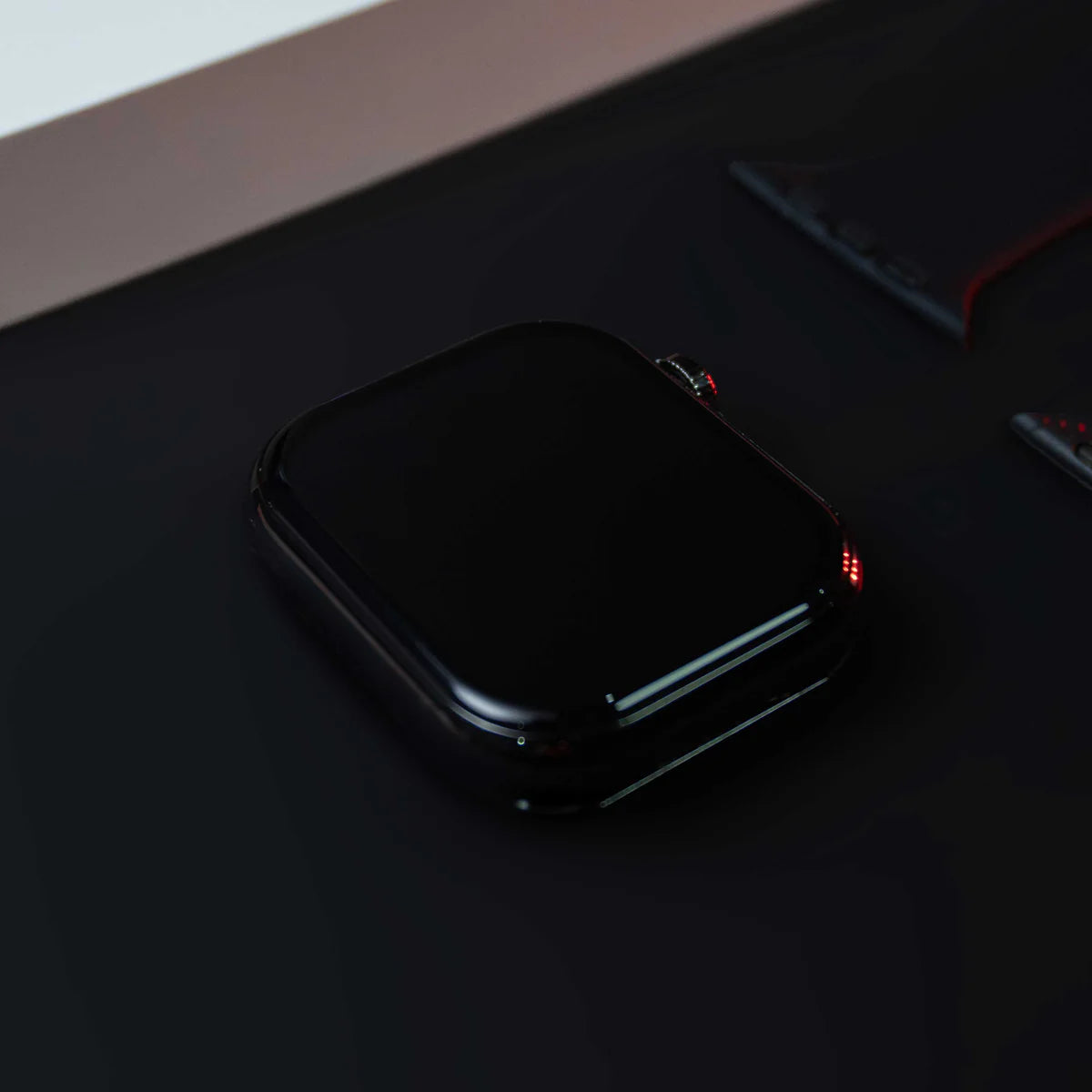 Black electronic device with red lights on a dark surface
