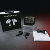 True wireless earbuds with charging case, packaging, and accessories on a dark surface.