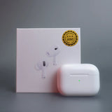 White wireless earbuds with charging case and box on a gray background