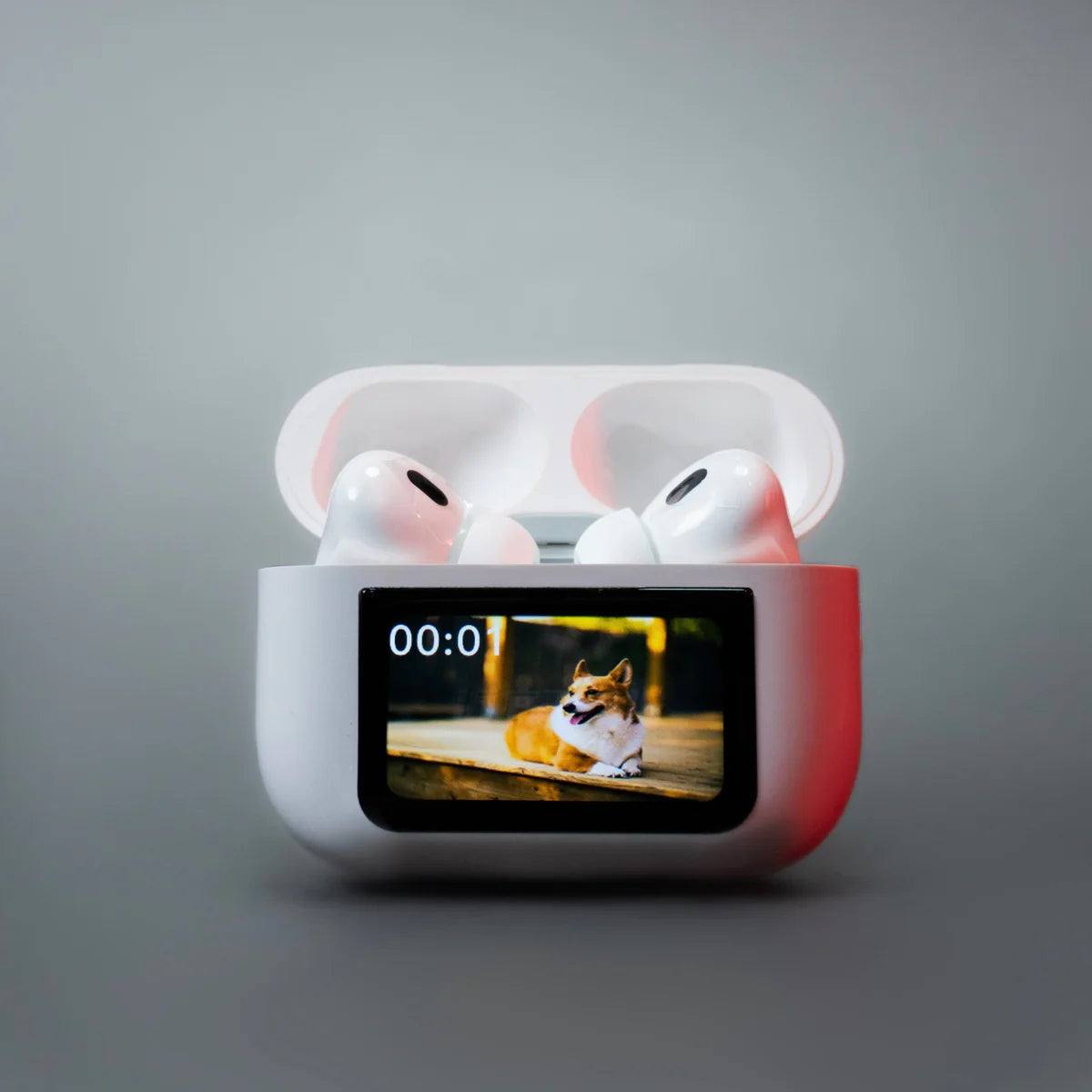 Wireless earbuds in a charging case with a screen displaying a dog on a gray background
